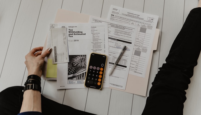 Calculator and financial documents on a desk representing insurance commission calculations