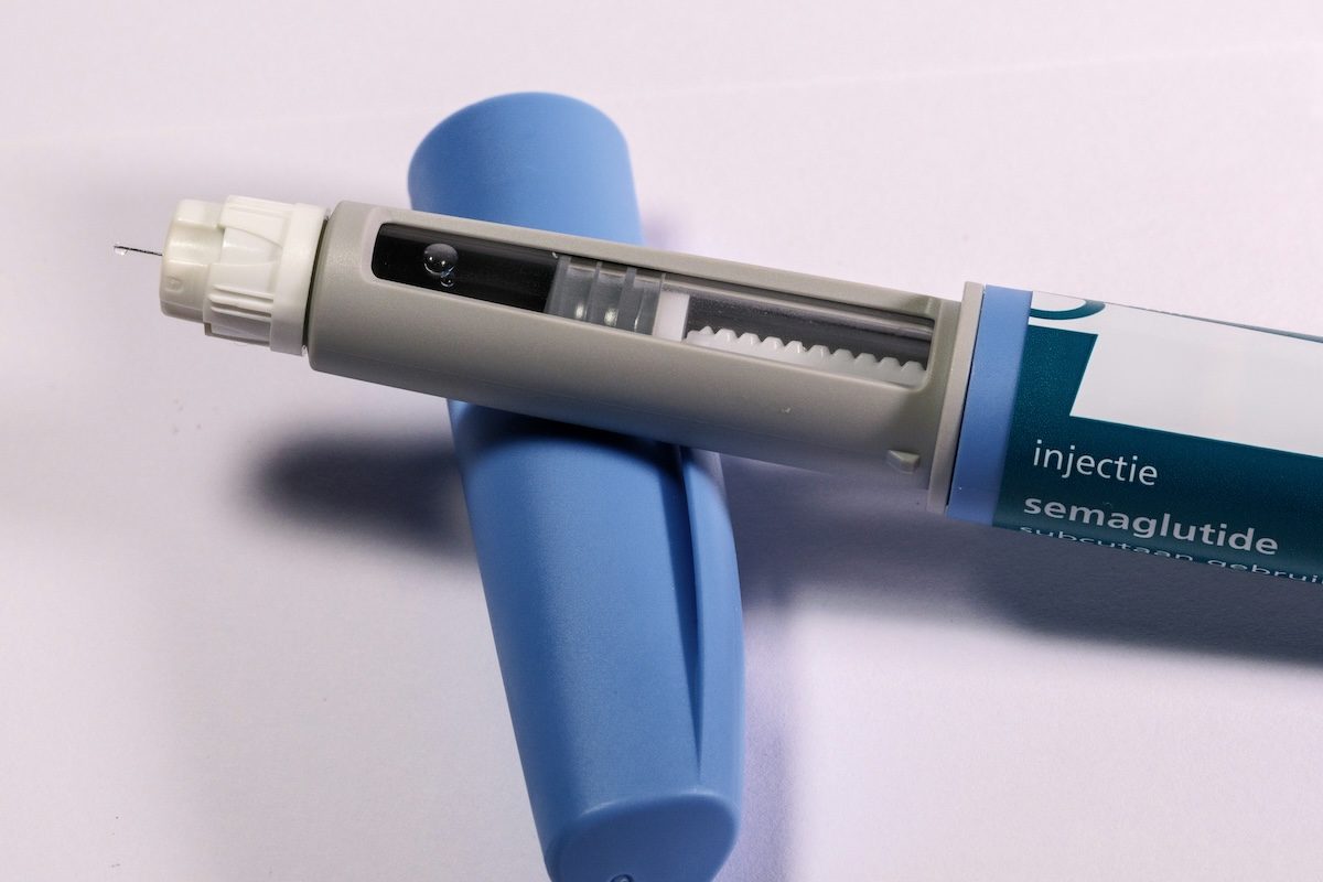Close-up of a semaglutide GLP-1 injection pen on a white background